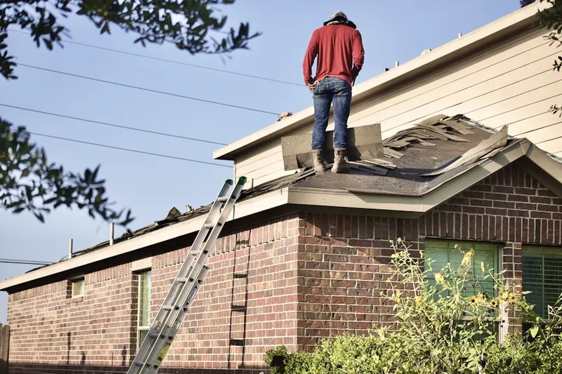 Professional roofer working on a residential roof in Century Estates